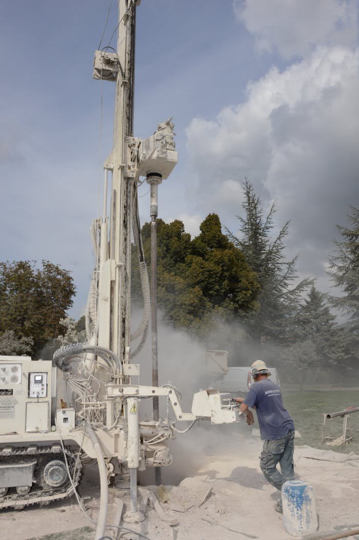 The Art of Drawing Readers In: Your attractive post title goes here A worker operates a large industrial drilling rig outdoors on a cloudy day.